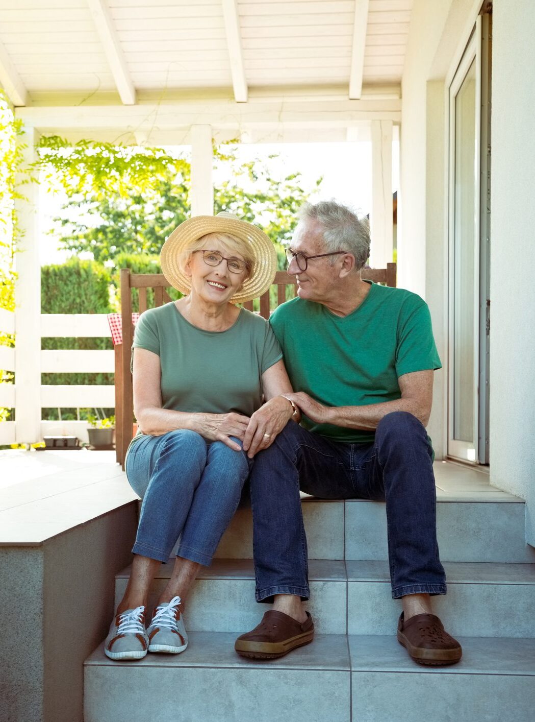 A happy older couple sitting on a porch